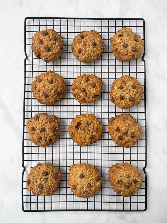 12 chunky chocolate chip oat cookies cooling on a wire rack
