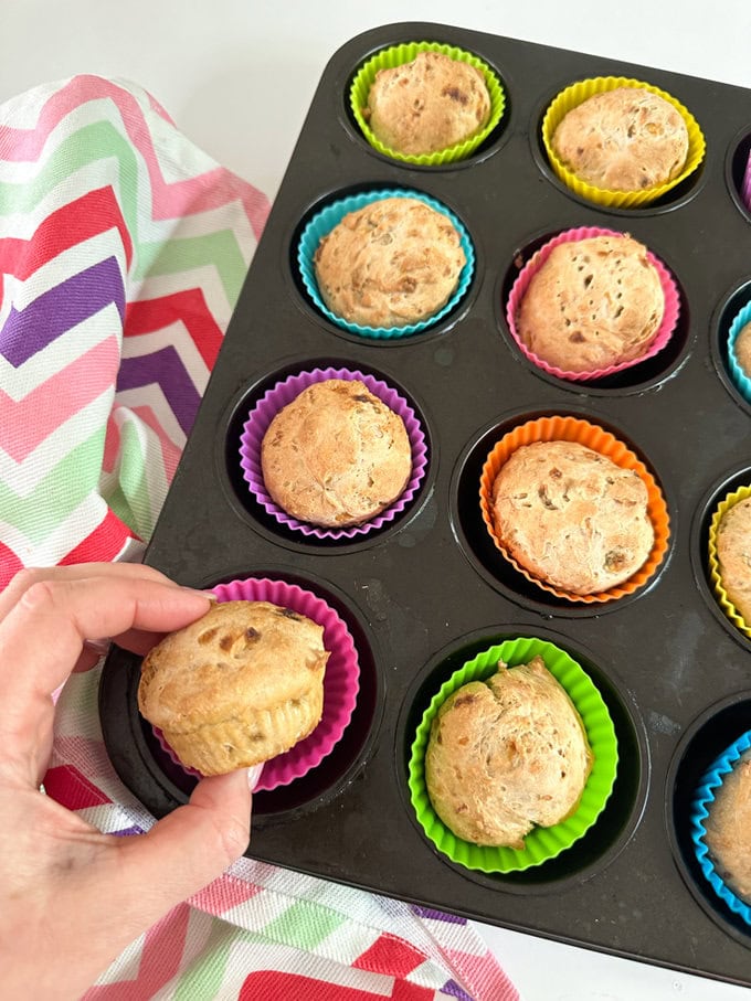 3 Ingredient Banana Muffins fresh out of the over in there brightly colored silicone muffin cases. 